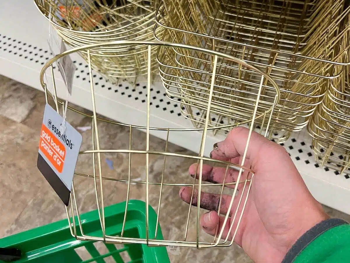 hand holding gold basket from the dollar store.