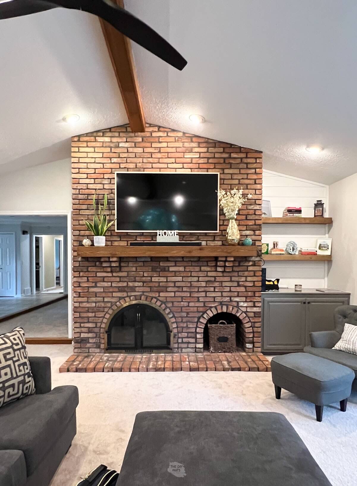 brown and red brick fireplace in living room.