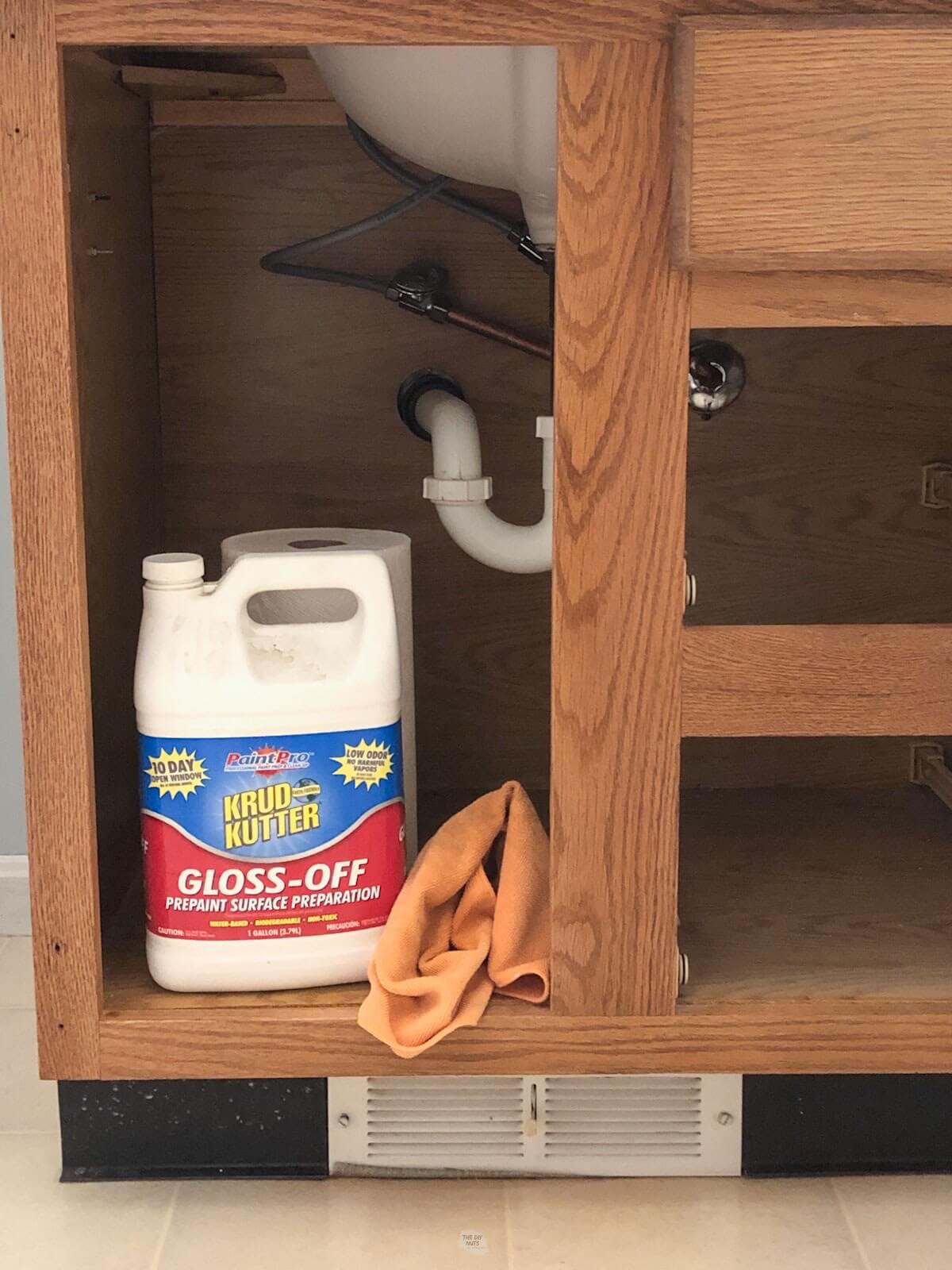 container of Krud Kutter surface prep siting in bathroom oak cabinet box.