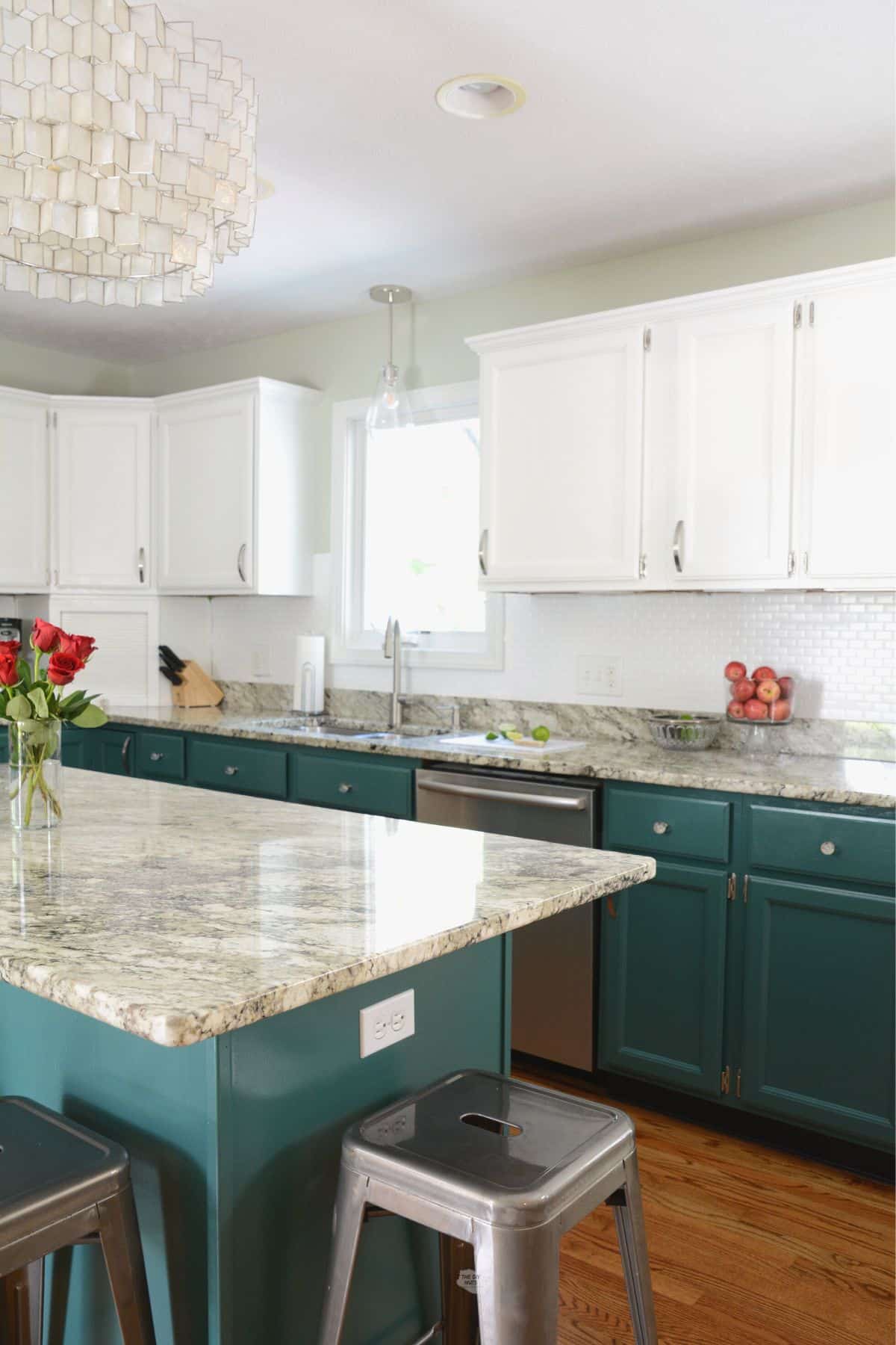 green lower kitchen cabinets with white upper kitchen cabinets.