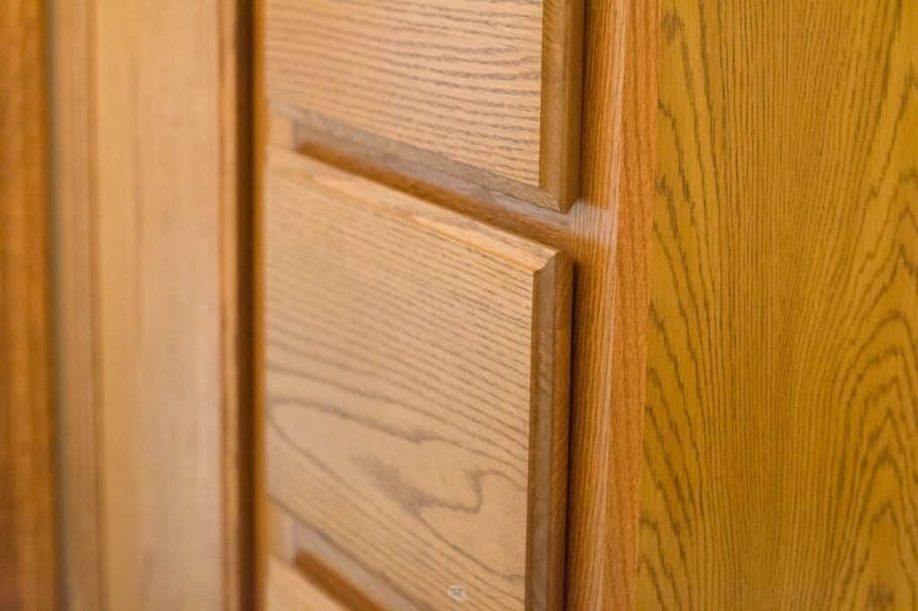 zoomed in view of orange oak cabinets and drawers.