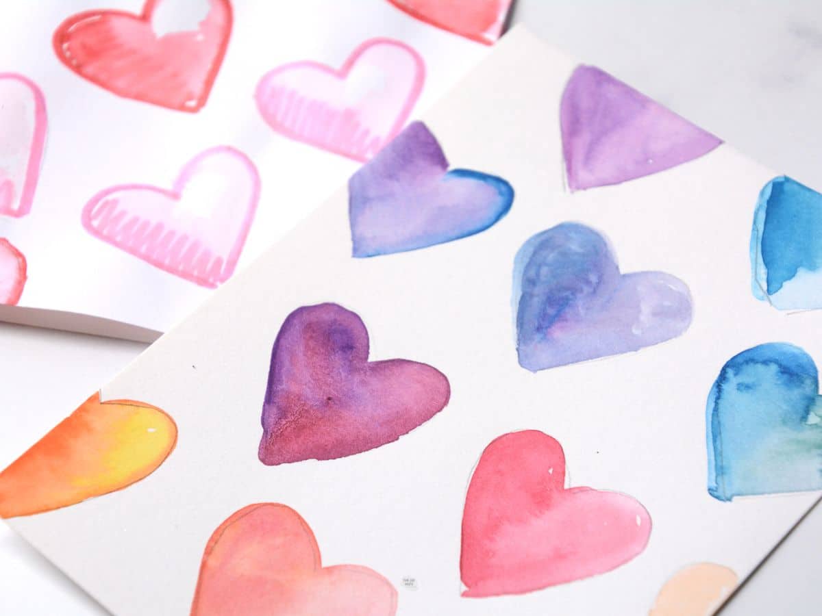 repeated watercolor hearts painted on card.