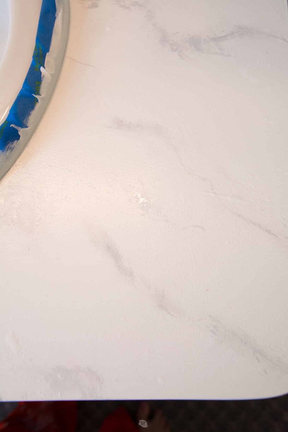 zoomed in view of faux marble painting on countertop.