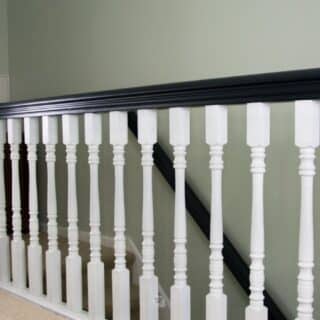 black and white painted oak stair rail and banister on steps.