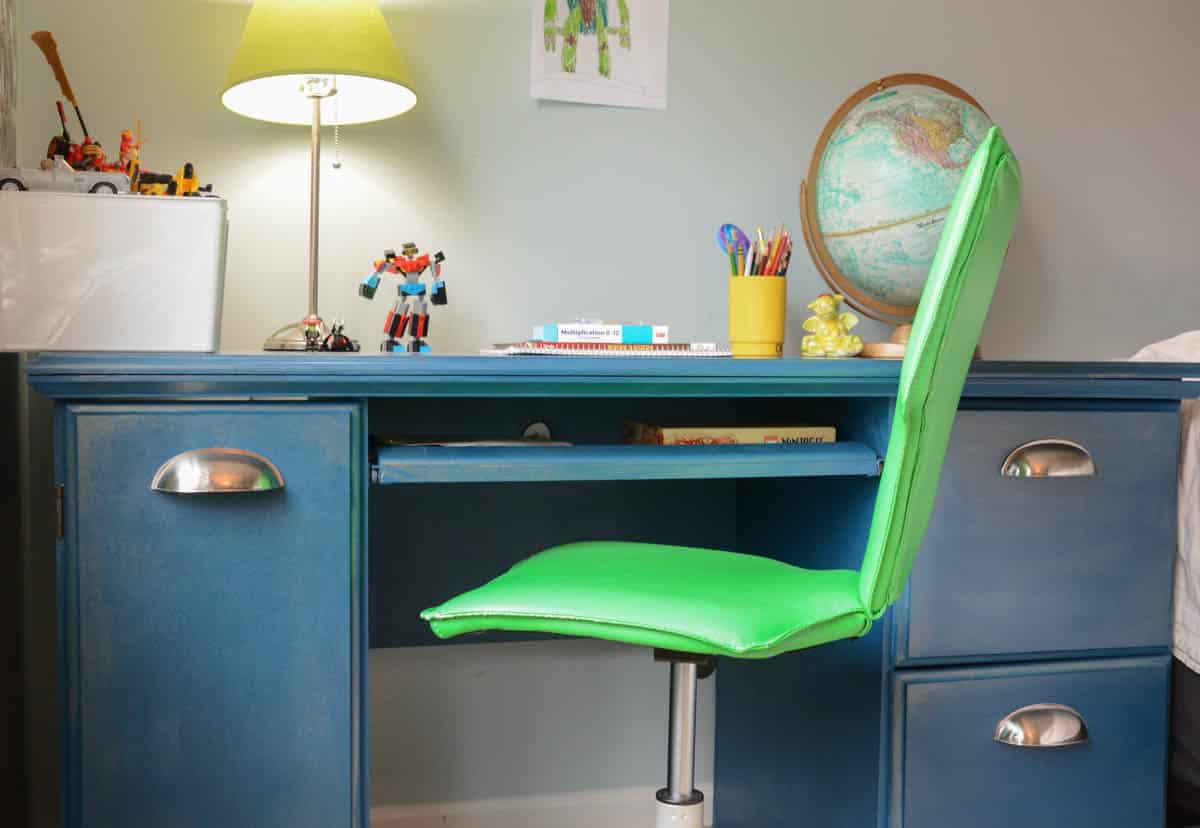 blue painted desk with green chair.