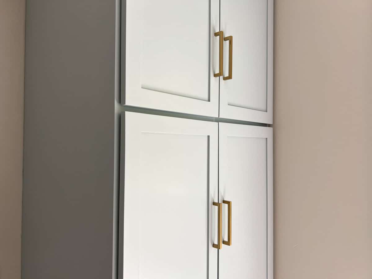 light blue cabinets with large gold handles.